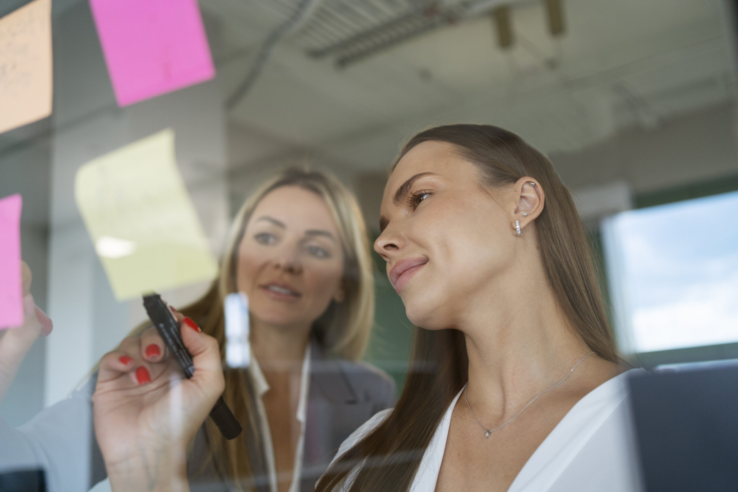 women-working-with-post-its-low-angle